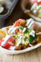 Get all of that layered bean dip flavor with much less work in these two-bite snacks. Like miniature bean burritos, these bean dip bites are topped with melty cheese, seasoned guacamole, fresh pico de gallo, and tangy sour cream. Finger food never tasted so good! These quick and easy Loaded Bean Dip Bites are the perfect snack for after school or while watching the big game.