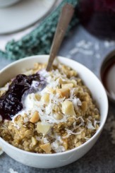 Raid your grocery store's bulk section to make this quick Creamy Coconut Oatmeal with Macadamia Nuts. Served with a spoonful of jam and a drizzle of cream, this breakfast will turn you into a morning person!