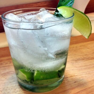 A glass of Brazilian Mojito on a table.