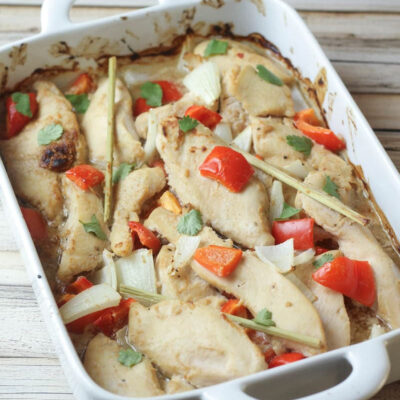 Thai chicken in peanut sauce baked in a white dish.