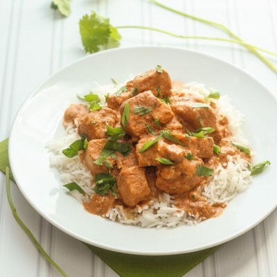 Healthy Chicken Tikka Masala on a white plate with rice.