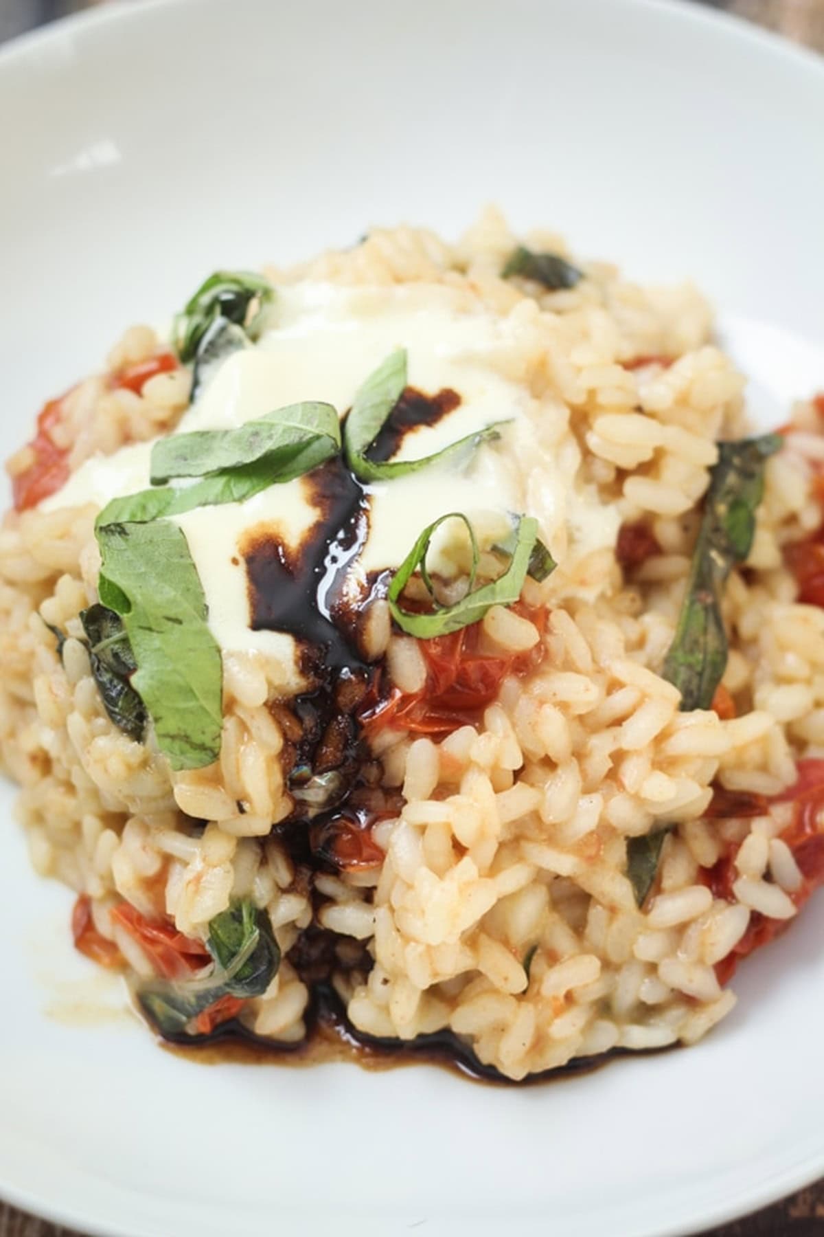 Mascarpone risotto with tomatoes and a drizzle of balsamic glaze.
