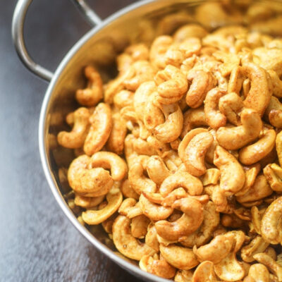 Curry Cashews in a metallic bowl.