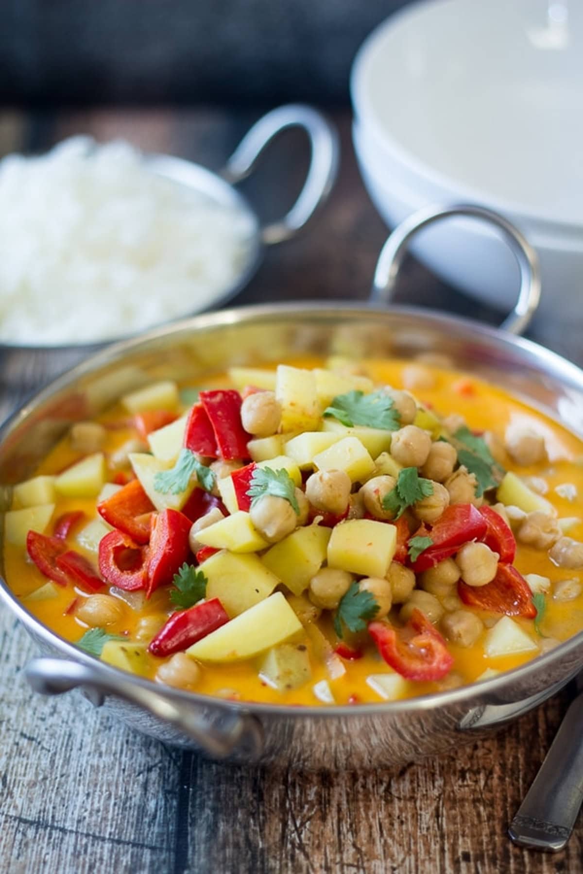 Overhead view of chickpea curry served in a metal bowl.