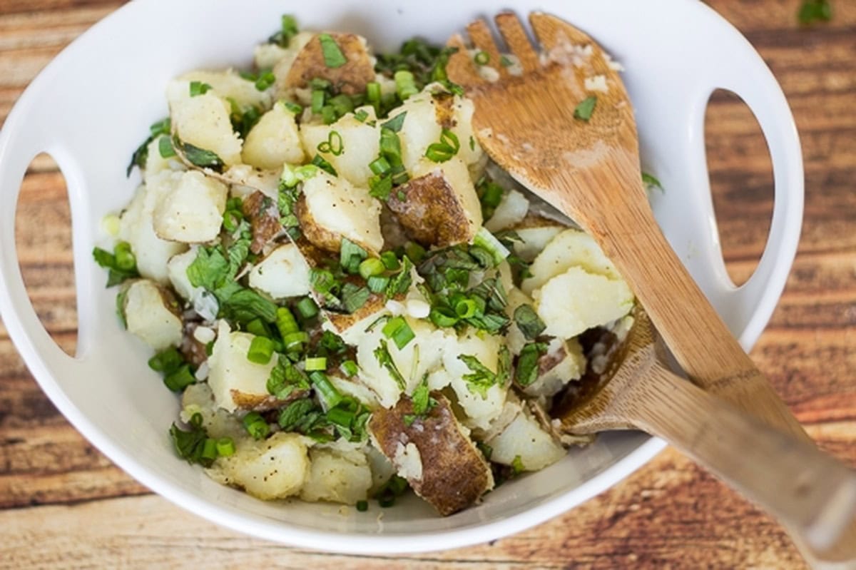 Close-up of Lebanese potato salad in a white bowl.