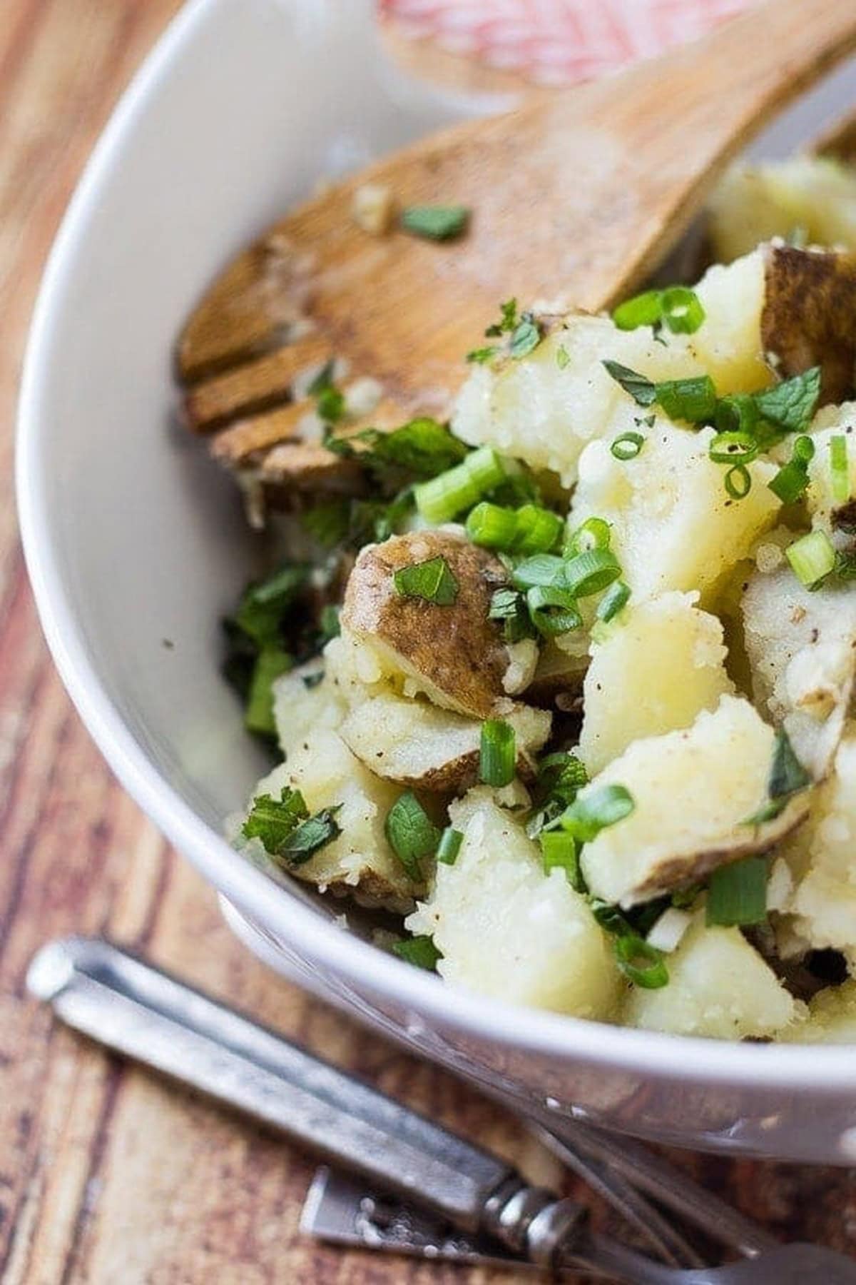 Lebanese potato salad in a white bowl.