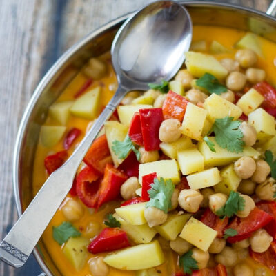 Thai chickpea curry served in a metal bowl.