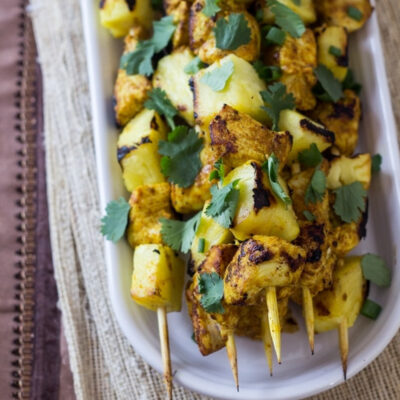Chicken Curry Skewers on a plate.