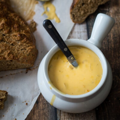 A bowl with a beer cheese soup.