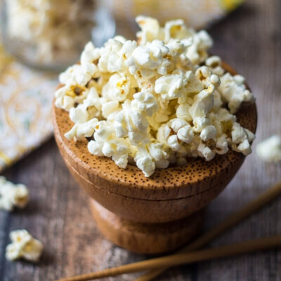 A wooden bowl filled with freshly popped wasabi popcorn.