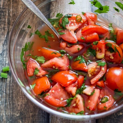 Thai Tomato Salad served in a glass bowl.