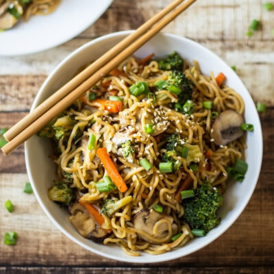 A bowl with healthy Chow Mein noodles served on a table.