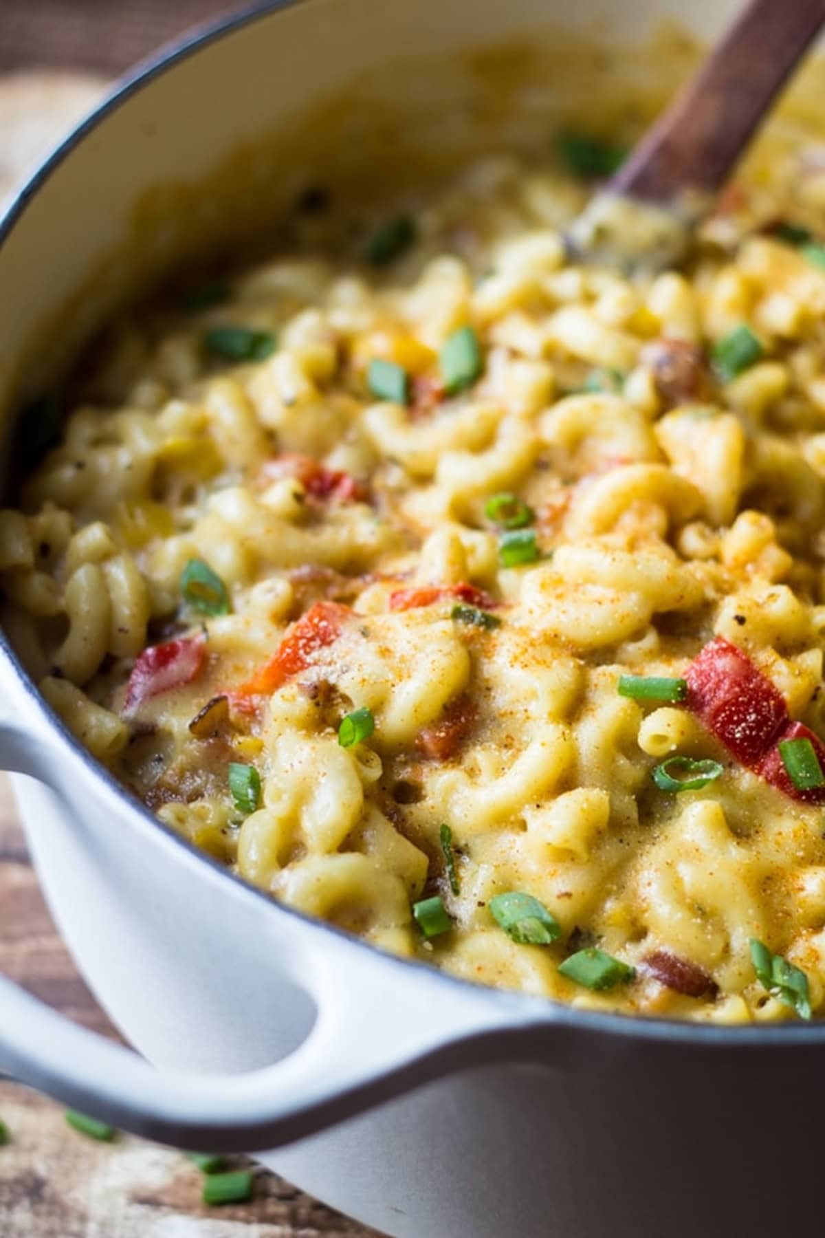 Cajun bacon mac and cheese in a white pot.