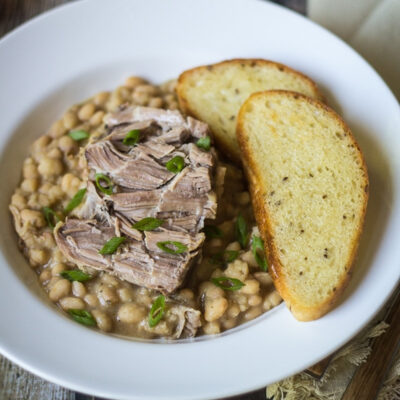 Italian Pork and Beans served on a white plate.