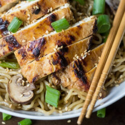 Garlic Ginger Chicken served on a bed of noodles.