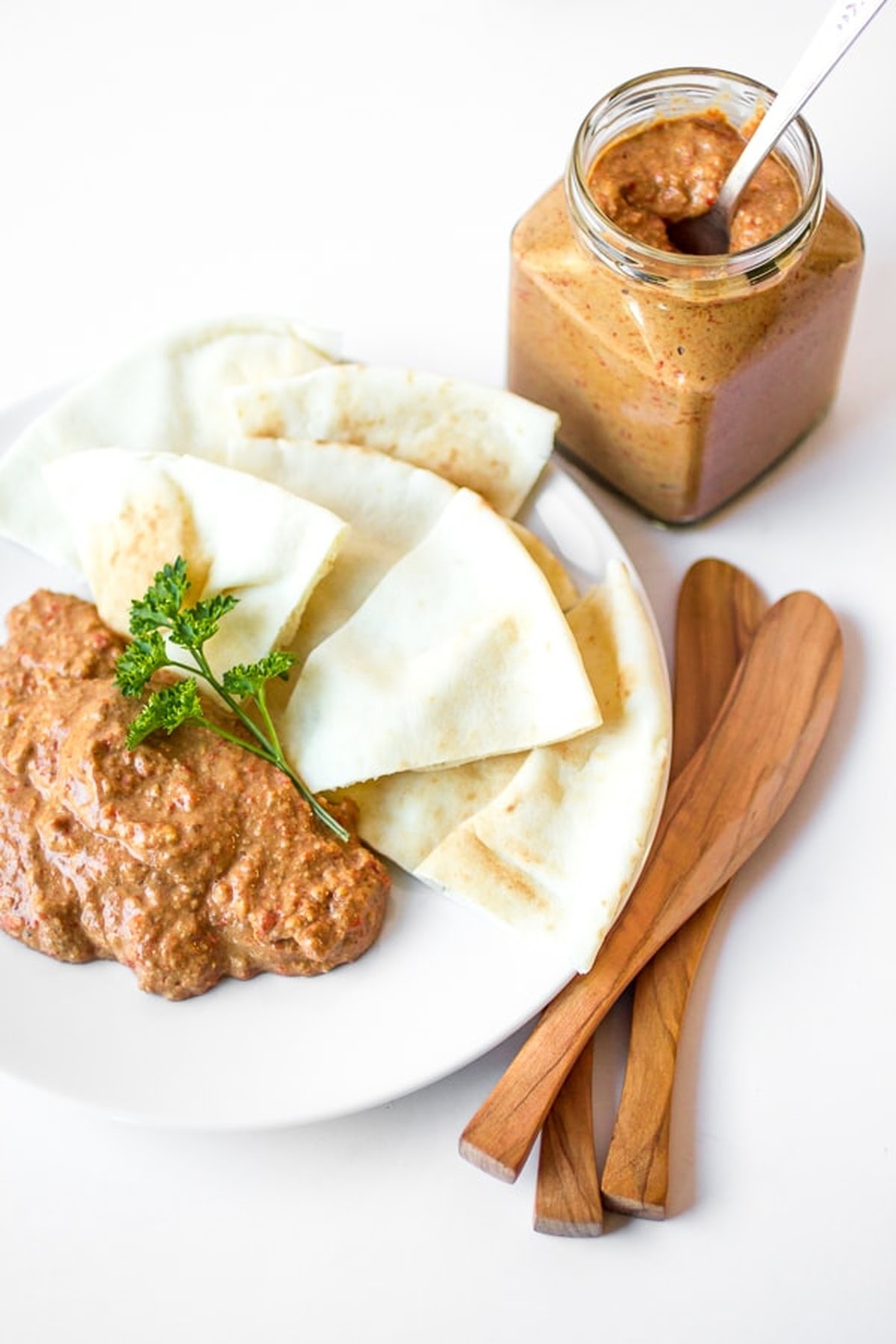 A plate with pita bread and Muhammara dip.