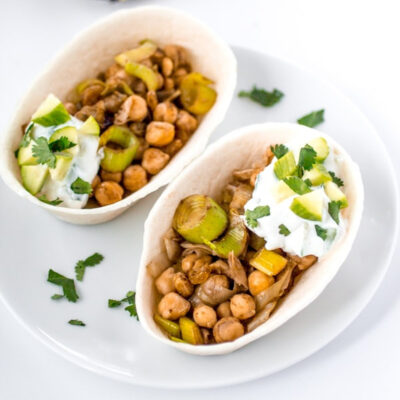 Taco bowls filled with chickpeas on a white plate.