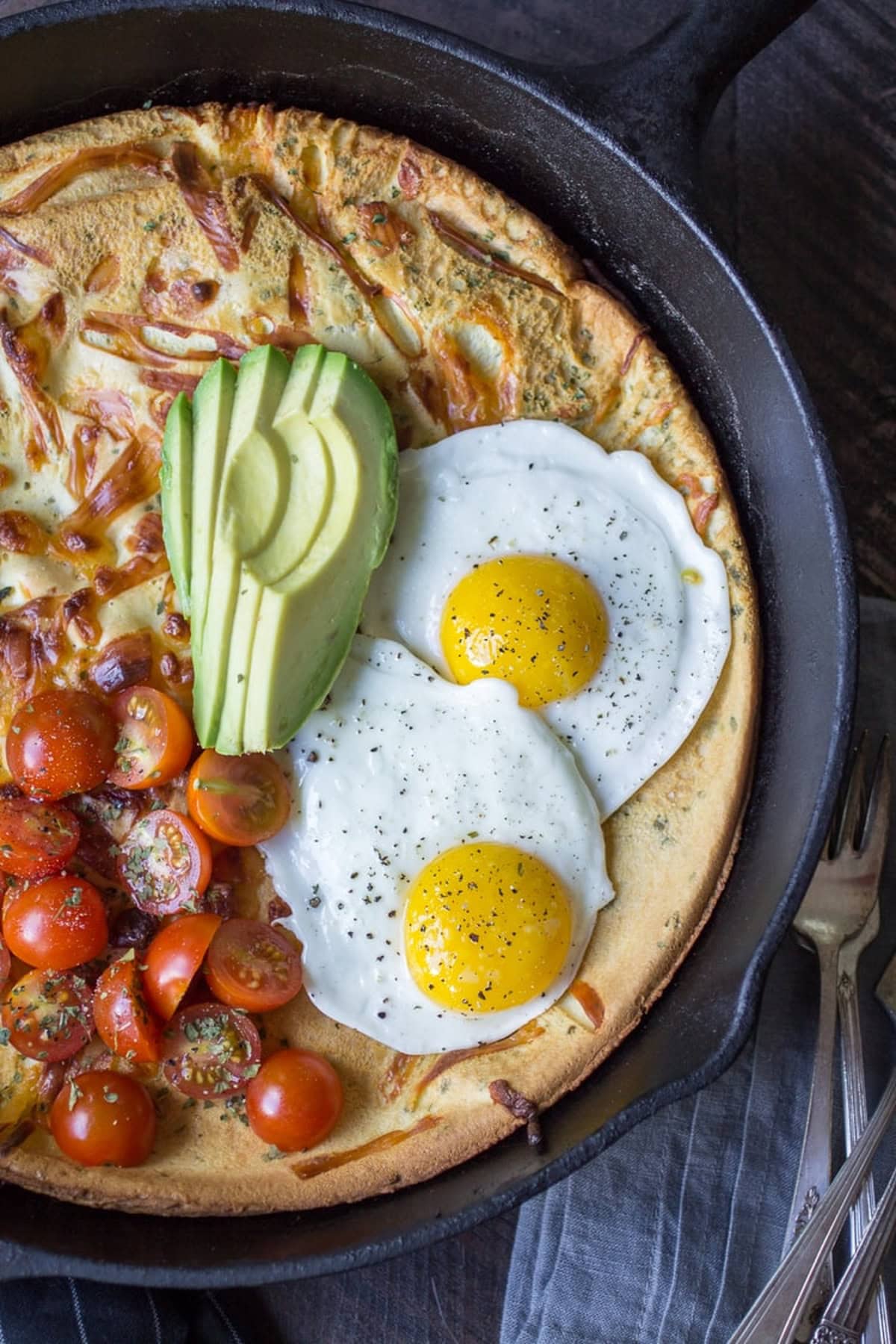 Savory Dutch baby in a cast iron skillet.