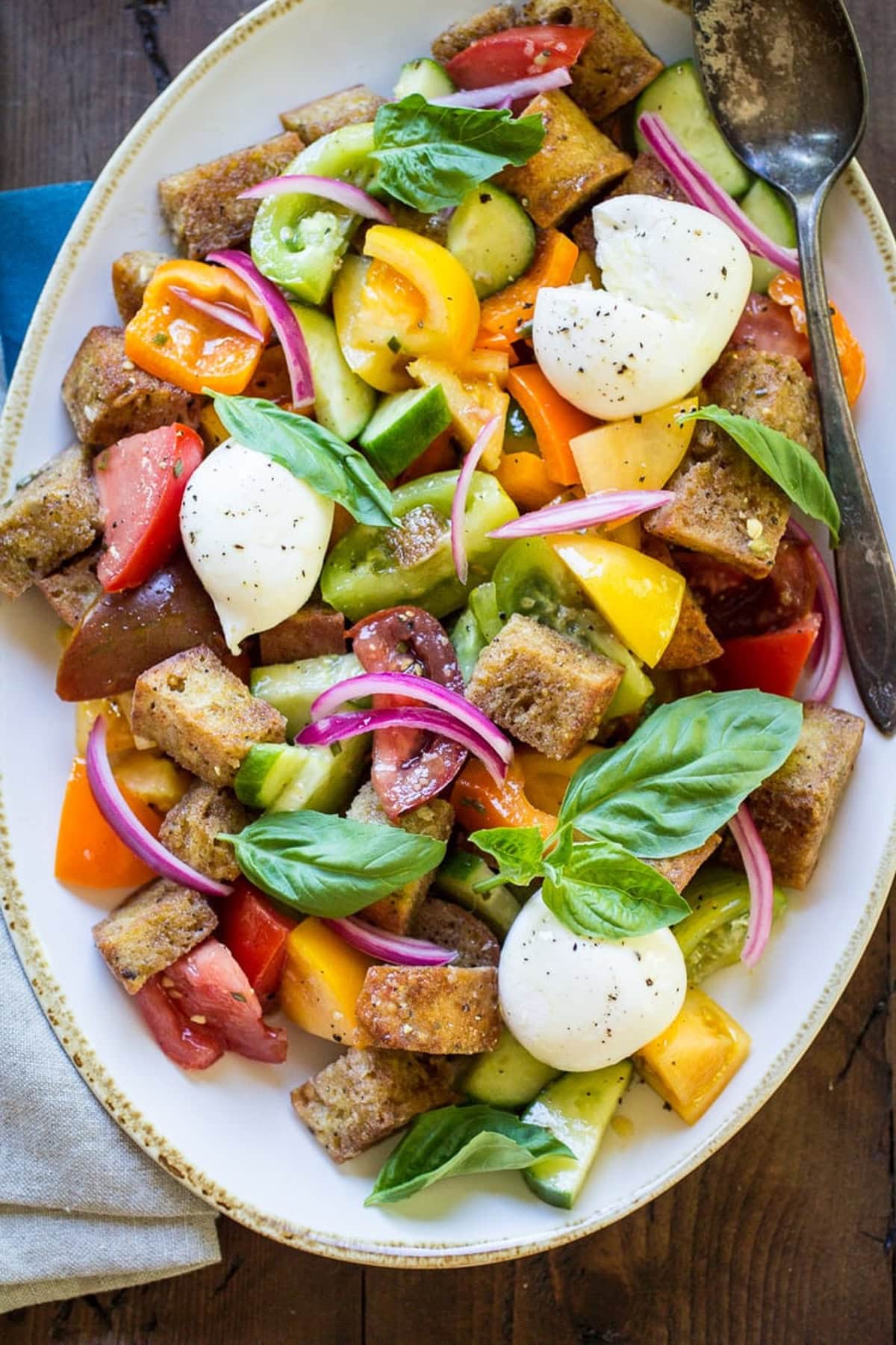 Panzanella salad on a white platter.