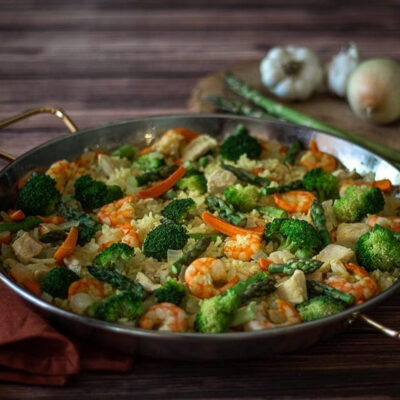 A large paella pan filled with Shrimp and Chicken Paella.
