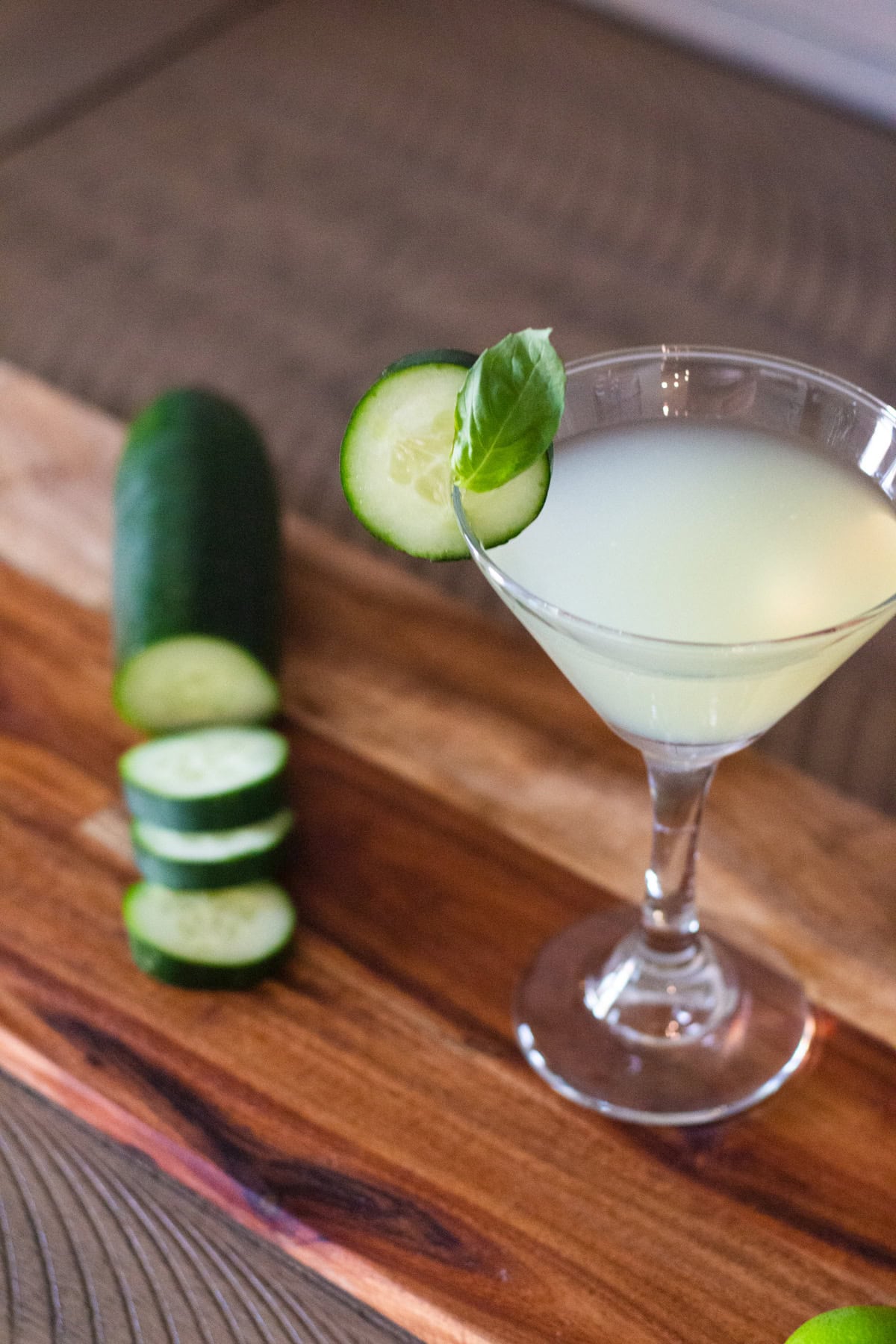 Cucumber martini on a cutting board.