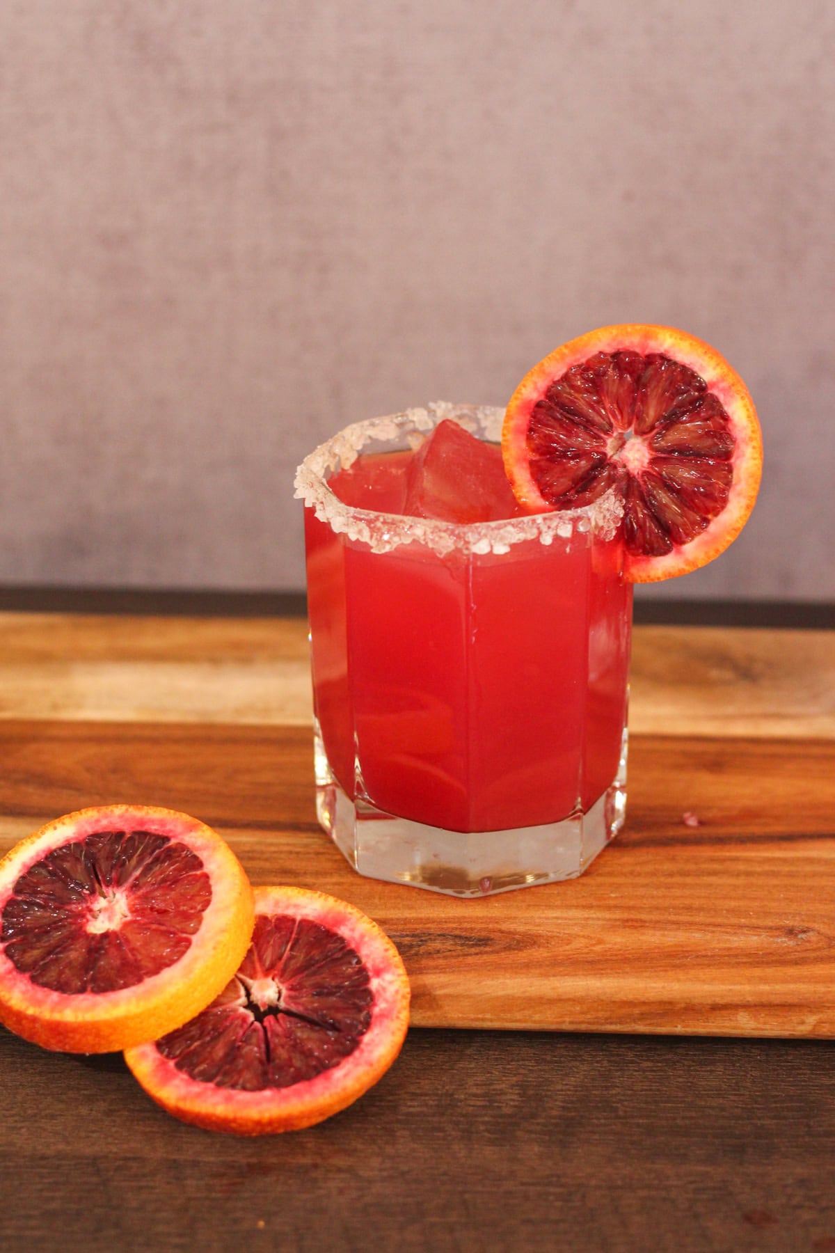 Blood orange margarita on a cutting board.