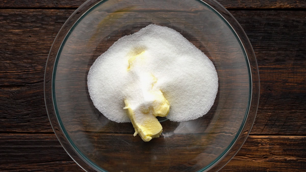 Butter and sugar in a glass bowl.