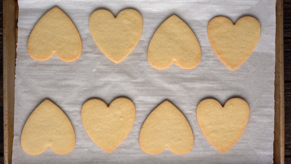 Heart cookies on a baking sheet after baking.