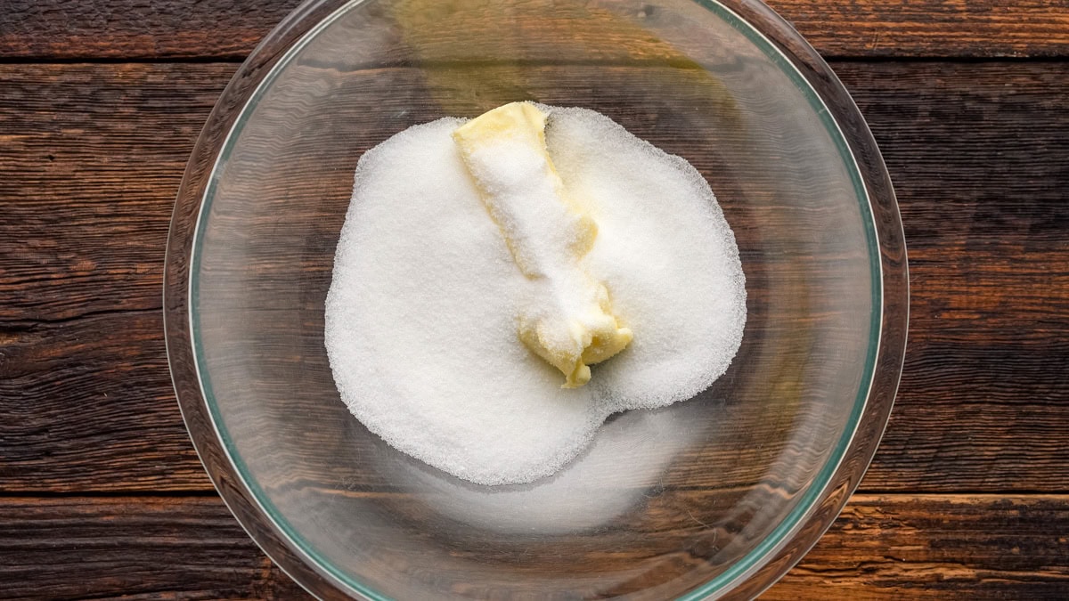 Butter and sugar in a glass bowl.