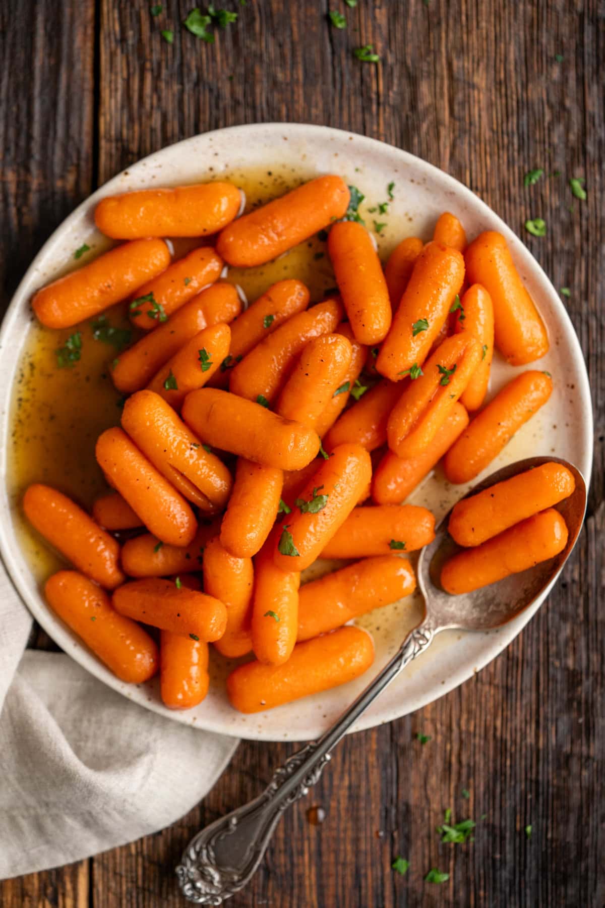 Brown sugar carrots on a white plate.