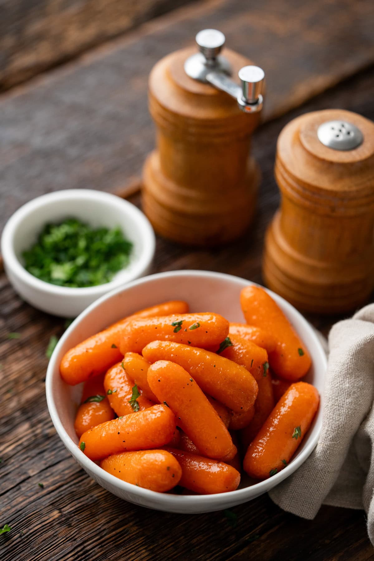 Brown sugar carrots in a white bowl.
