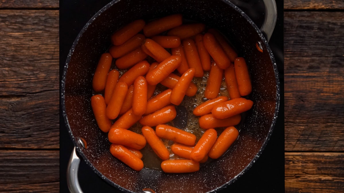 Brown sugar carrots cooking in a pot.