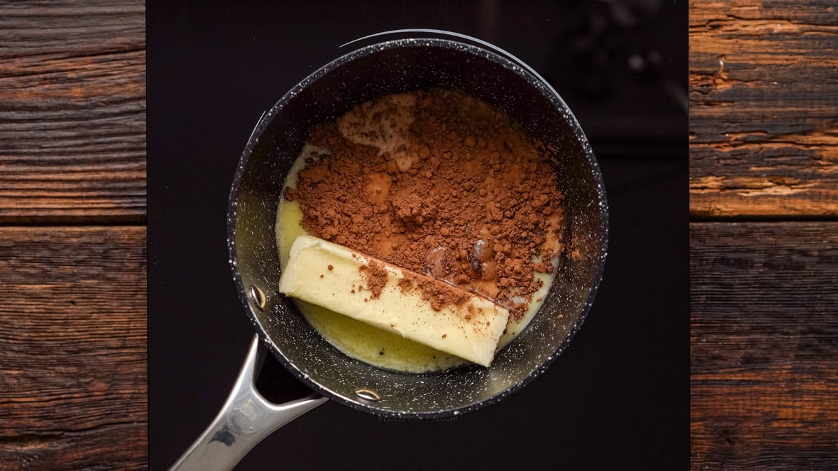 Butter, cocoa powder, and milk in a saucepan.