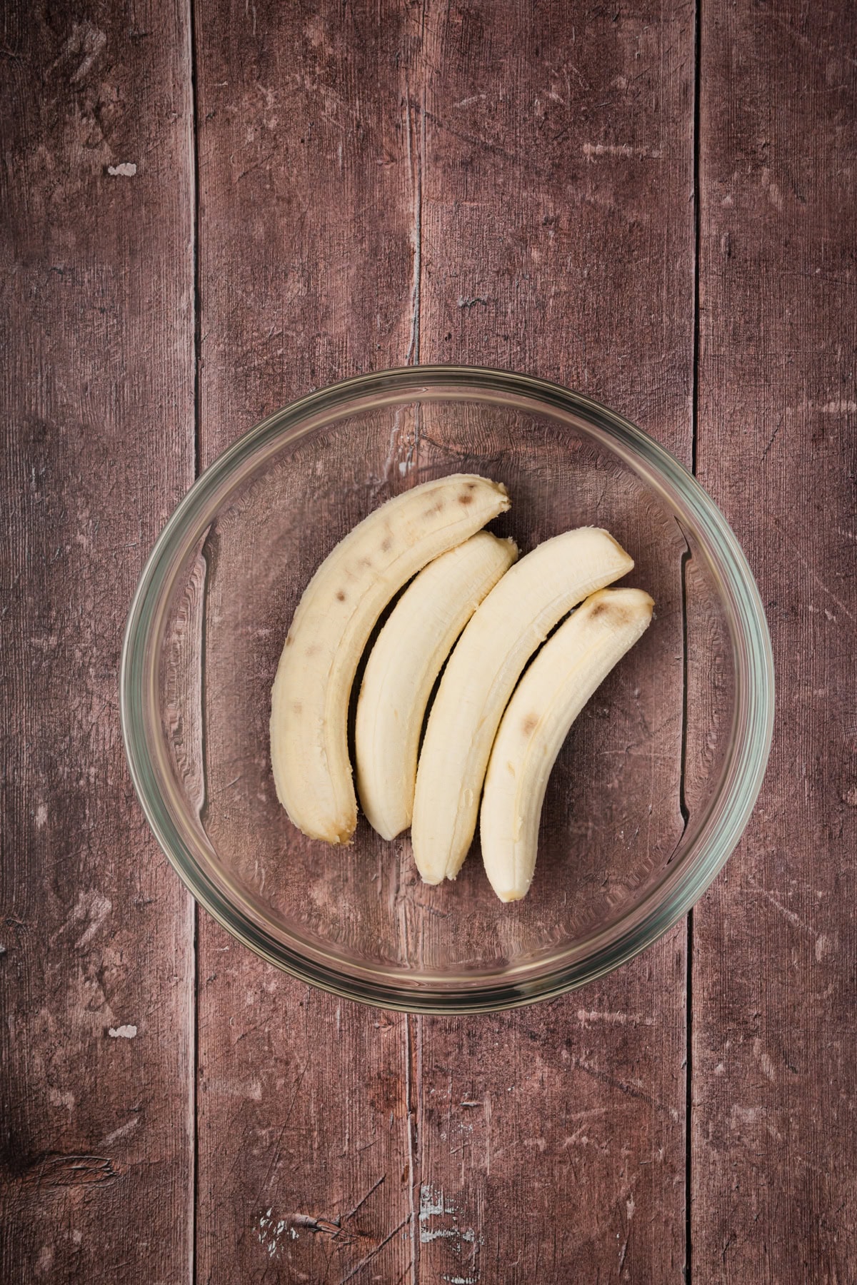 Bananas in a glass bowl.