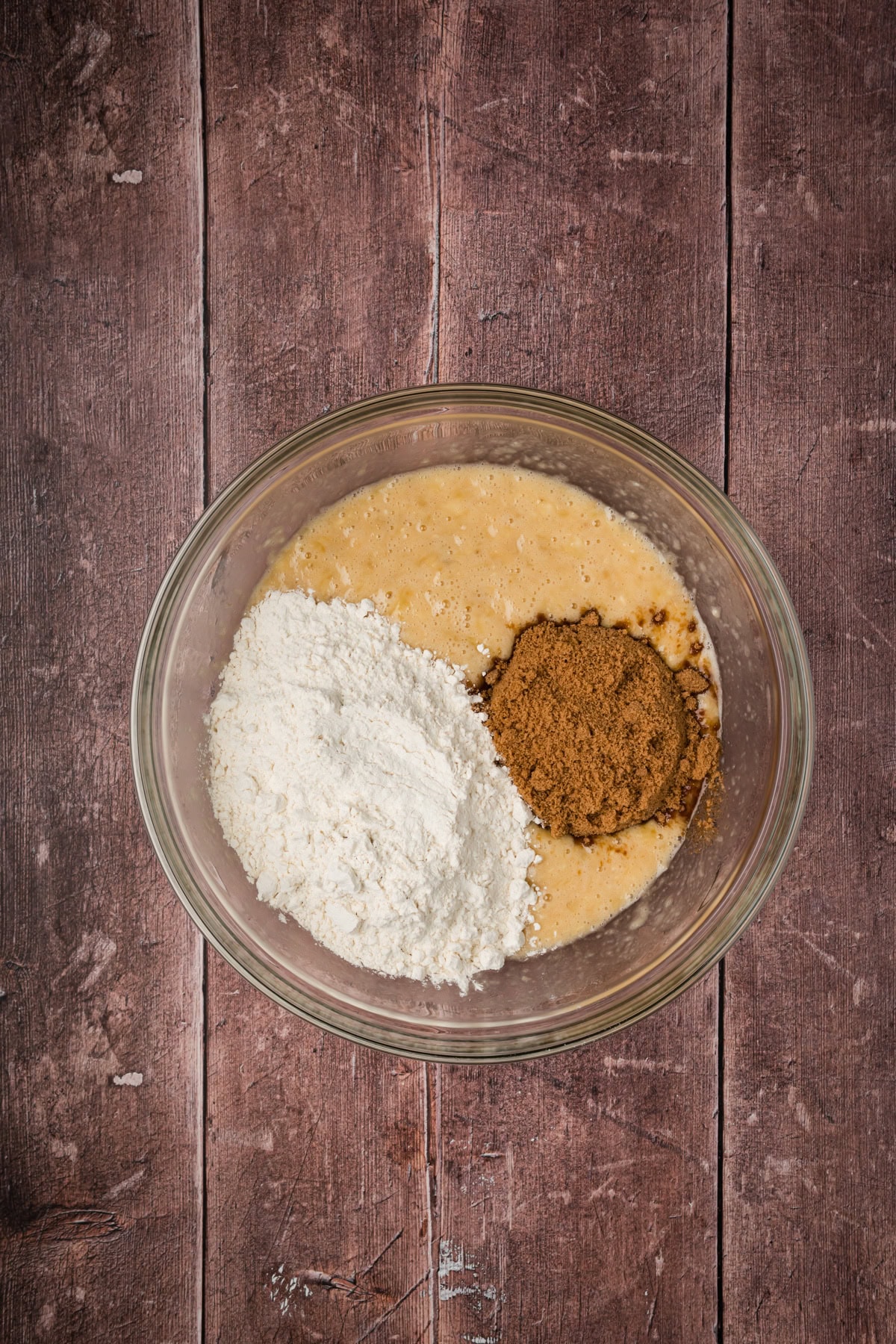 Flour and brown sugar added into the glass bowl.