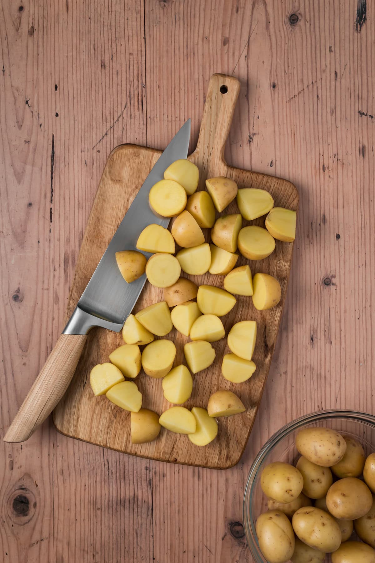 Potatoes cut on a cutting board.