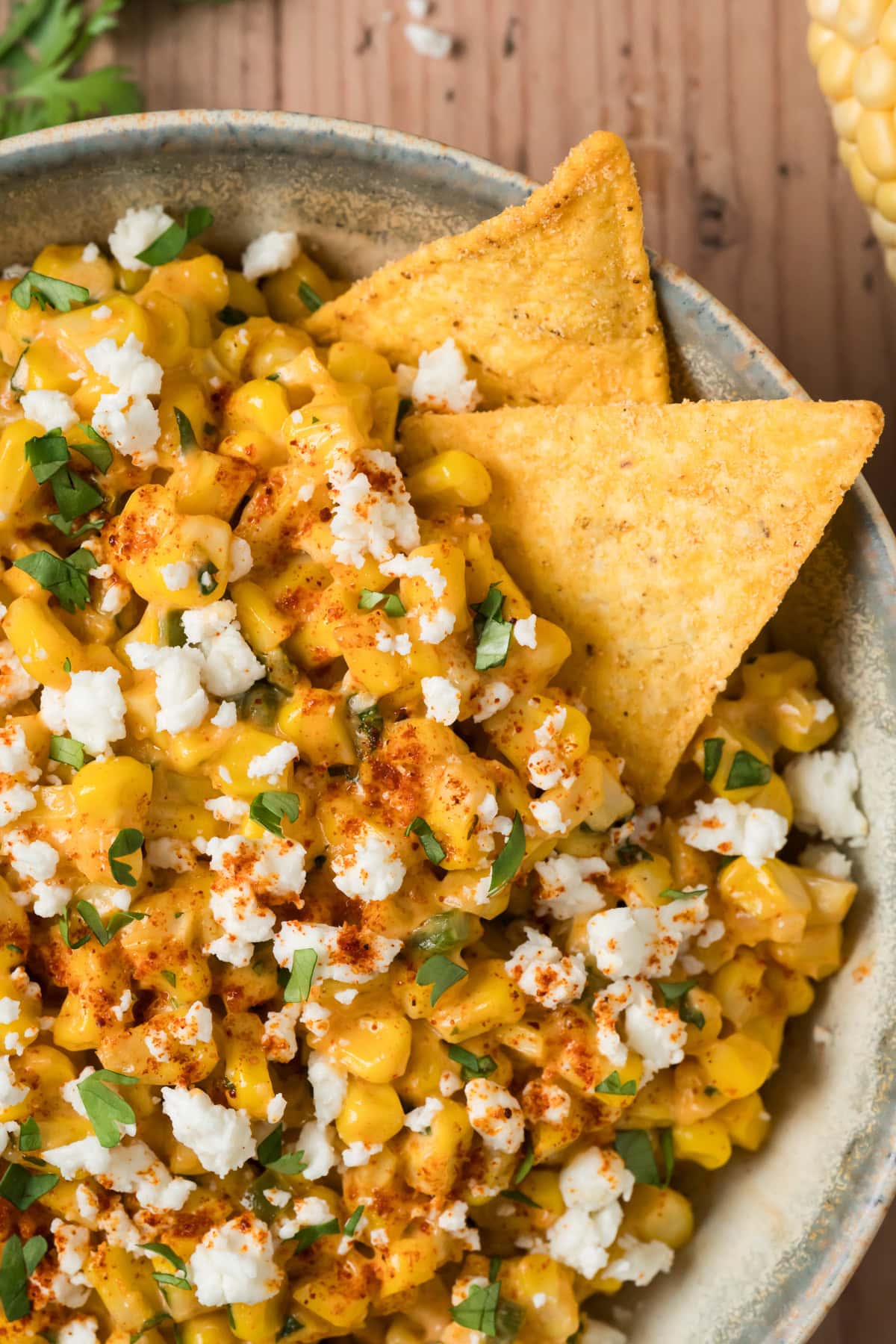 Elote dip in a bowl with tortilla chips.