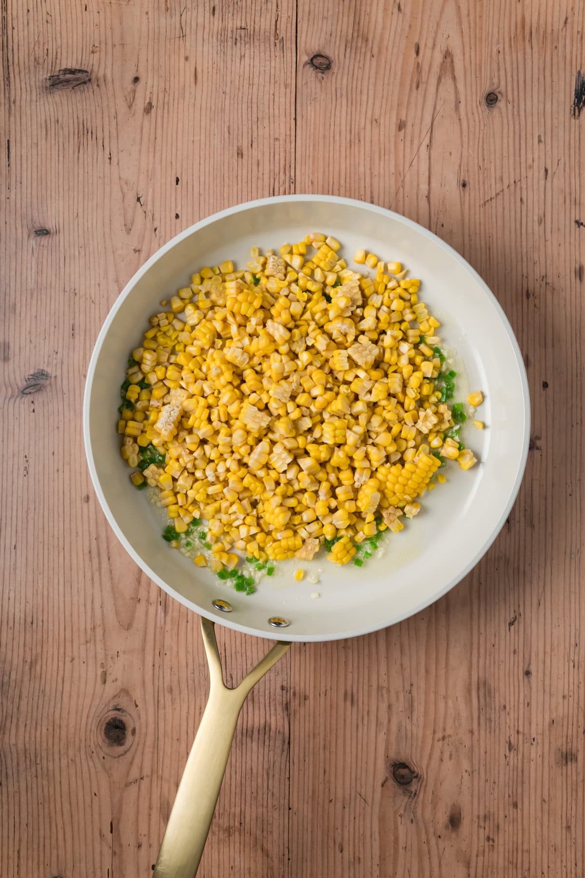 Corn added to the pan. 