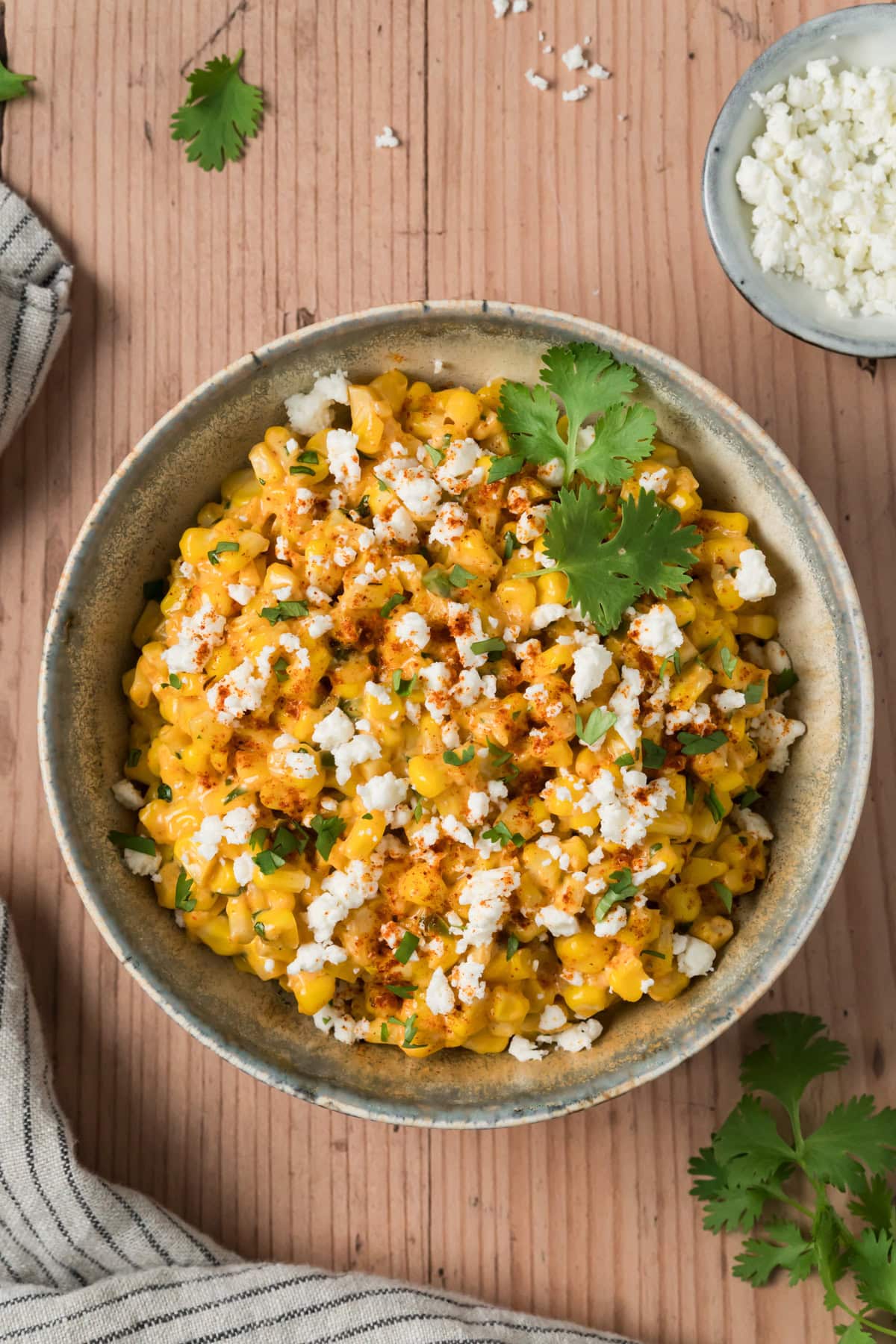 Elote dip in a bowl and topped with cotija cheese.