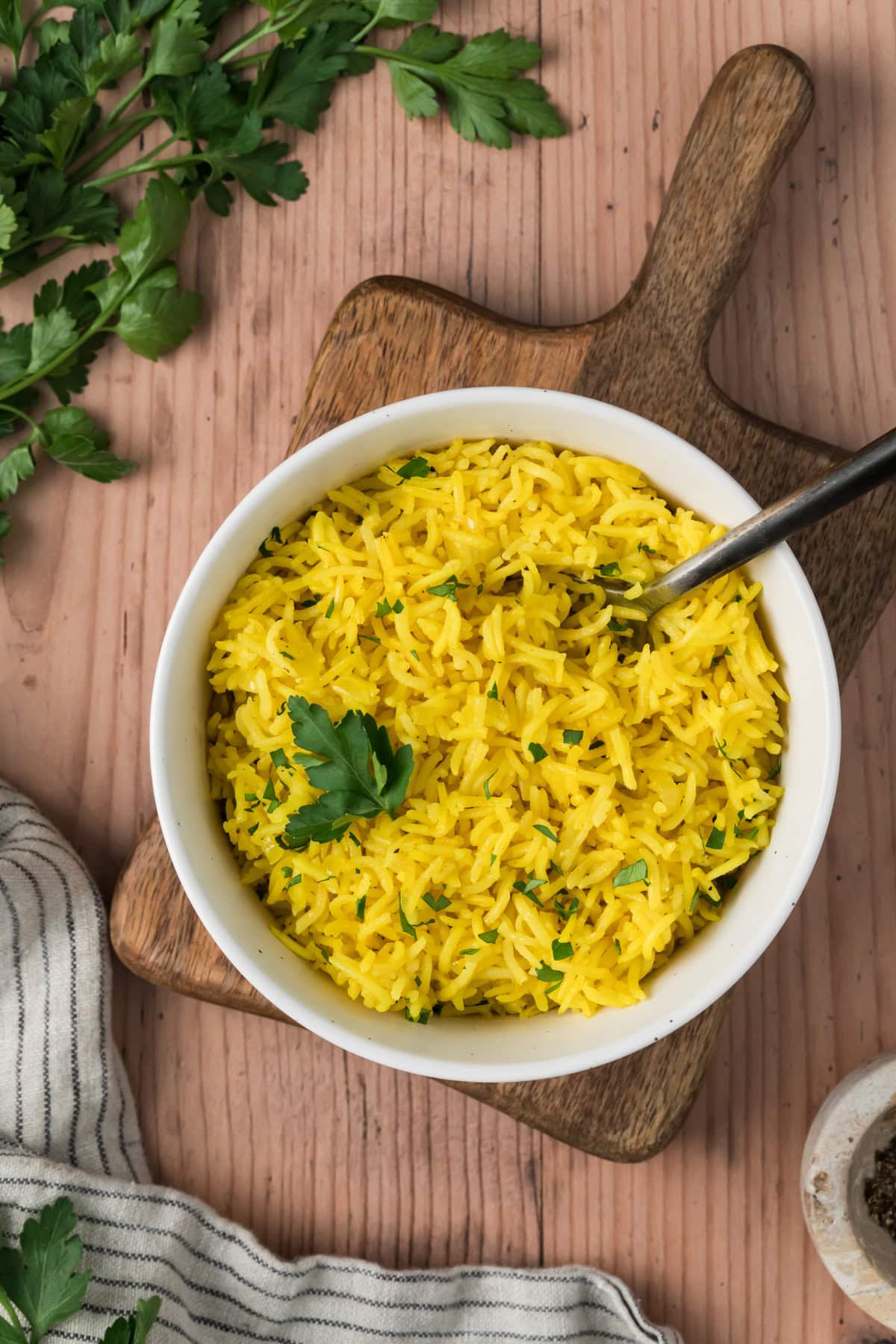 Turmeric rice in a white bowl.