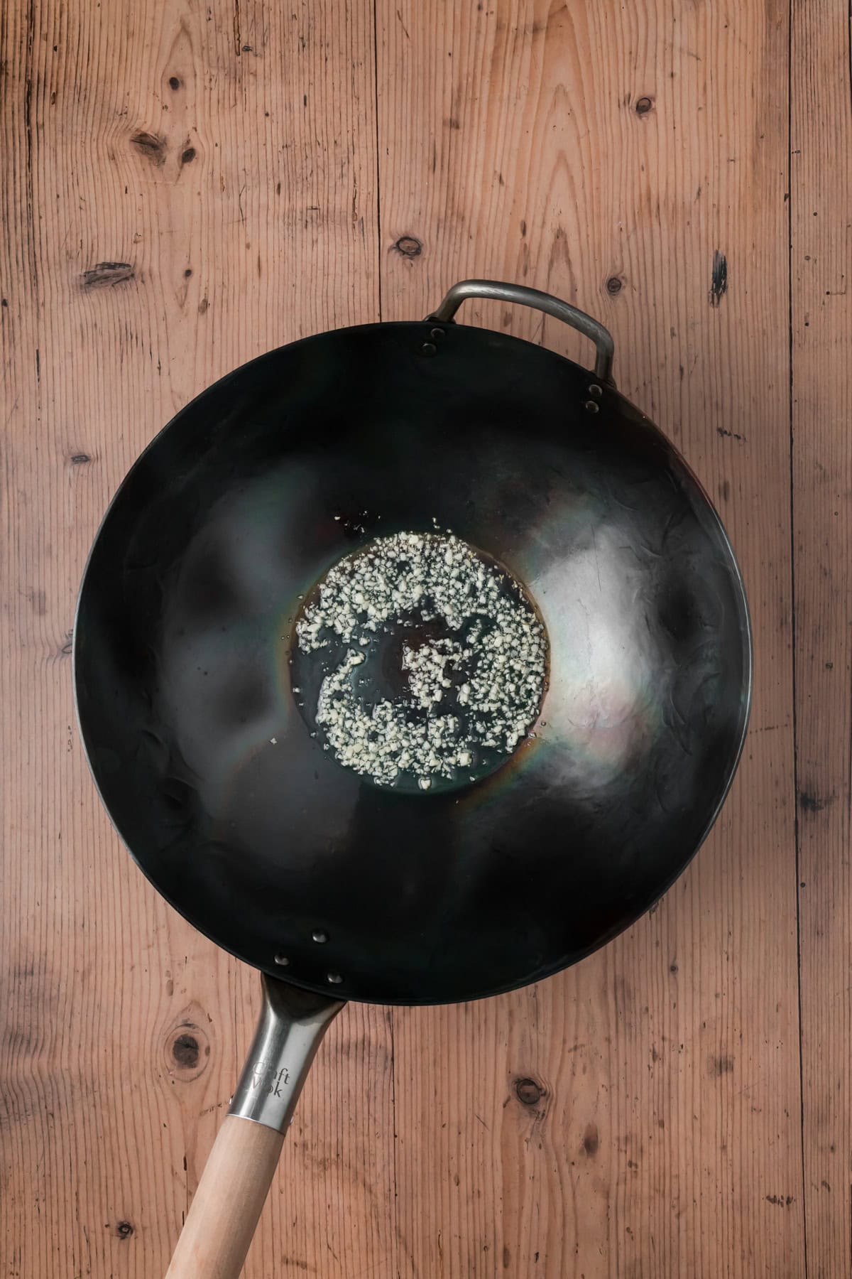 Garlic and oil cooking in a wok.
