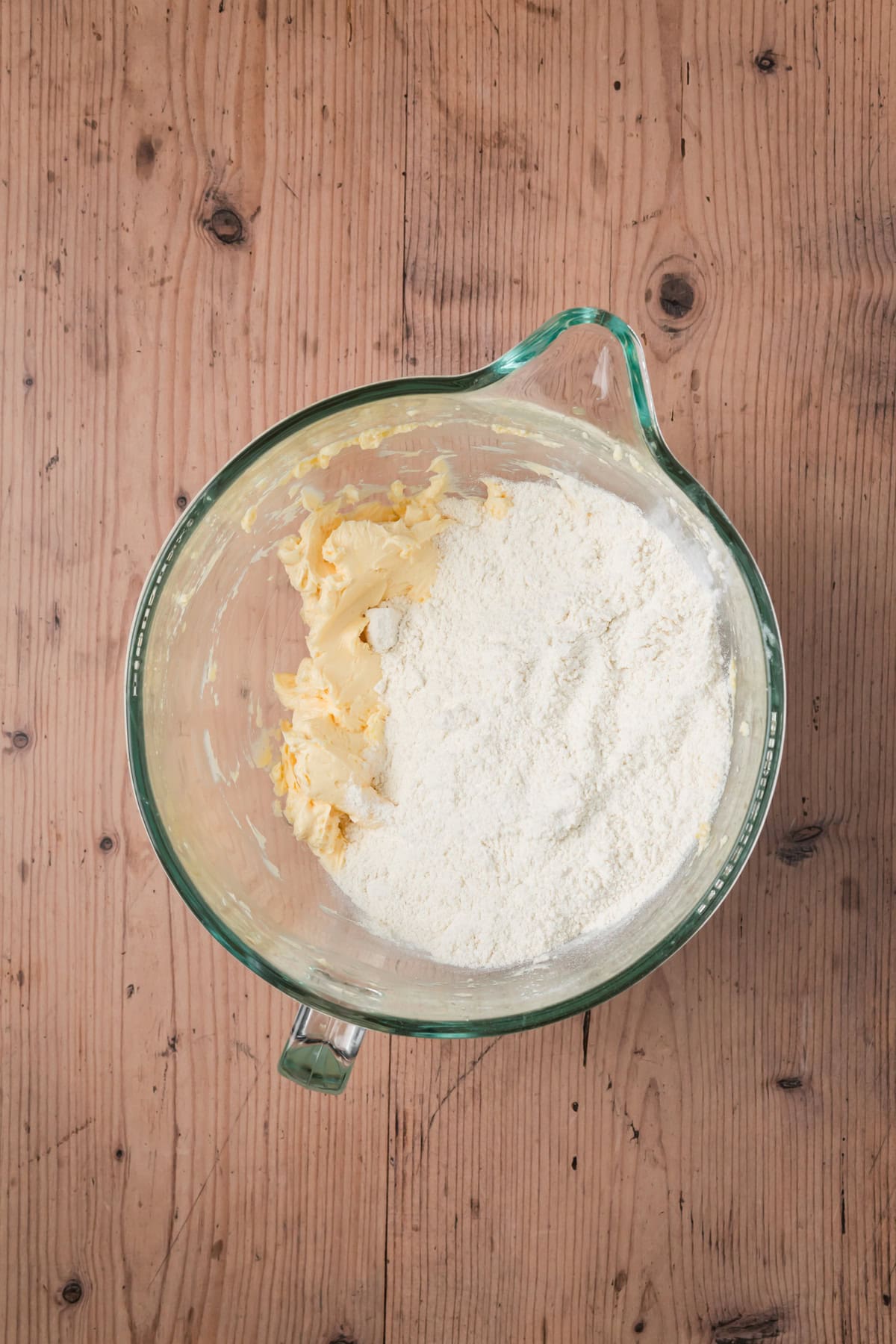 Dry and wet ingredients in a glass bowl.