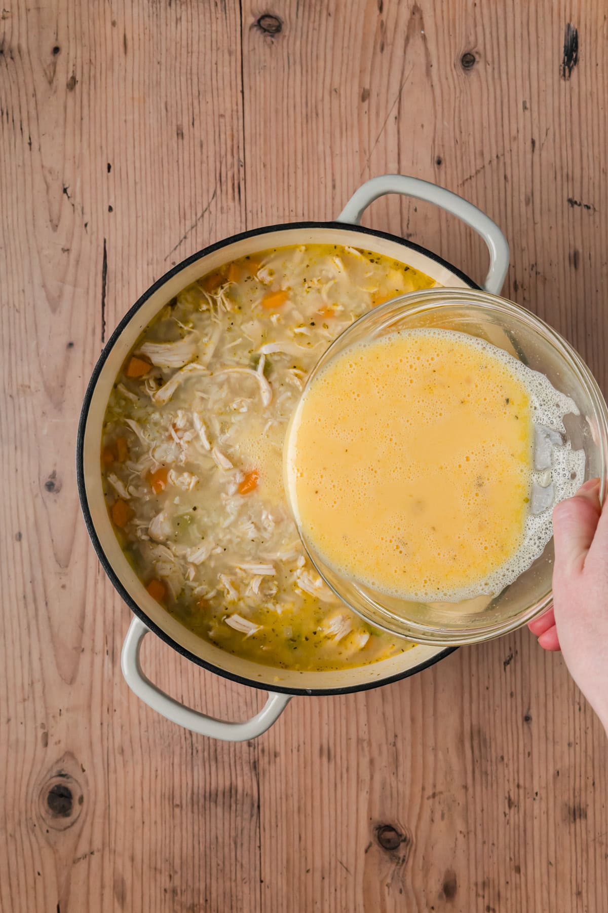 Egg mixture being added into the soup.