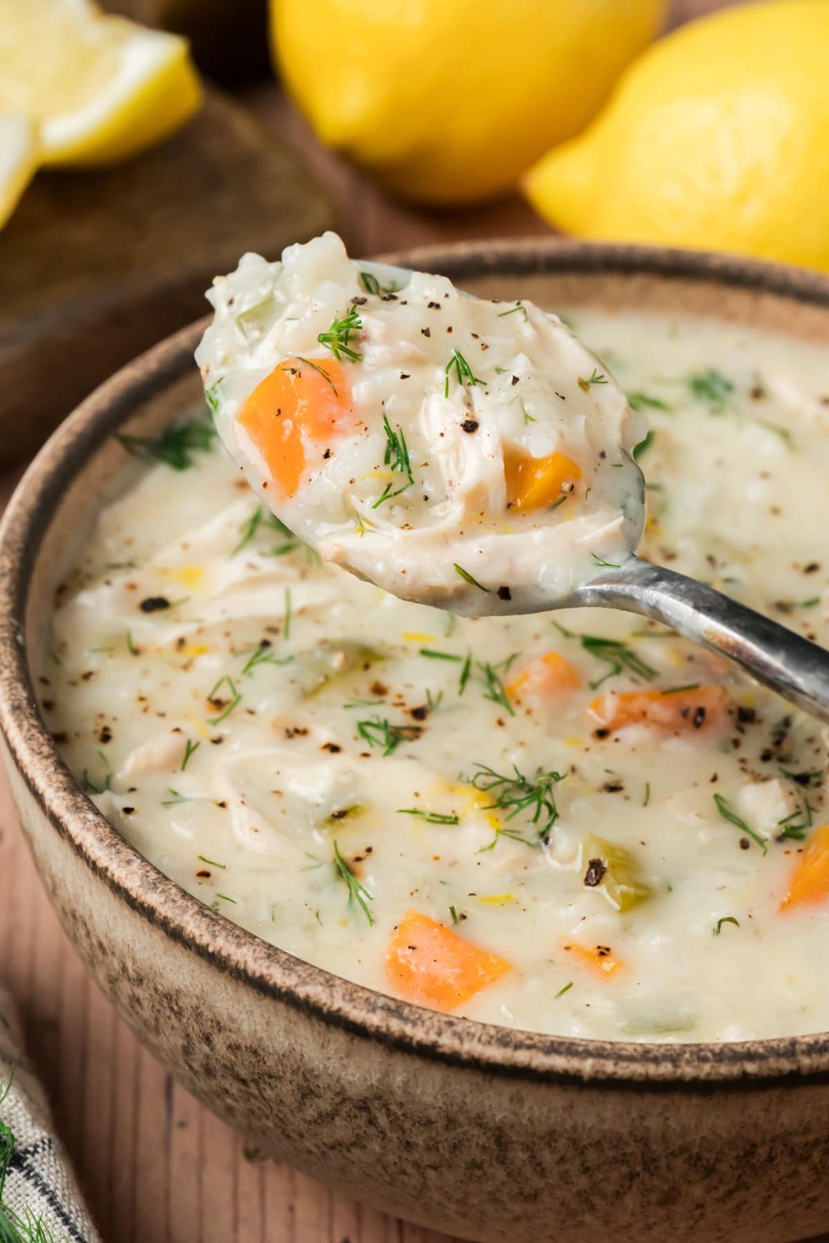 Bowl of Avgolemono Soup with a spoon coming out.