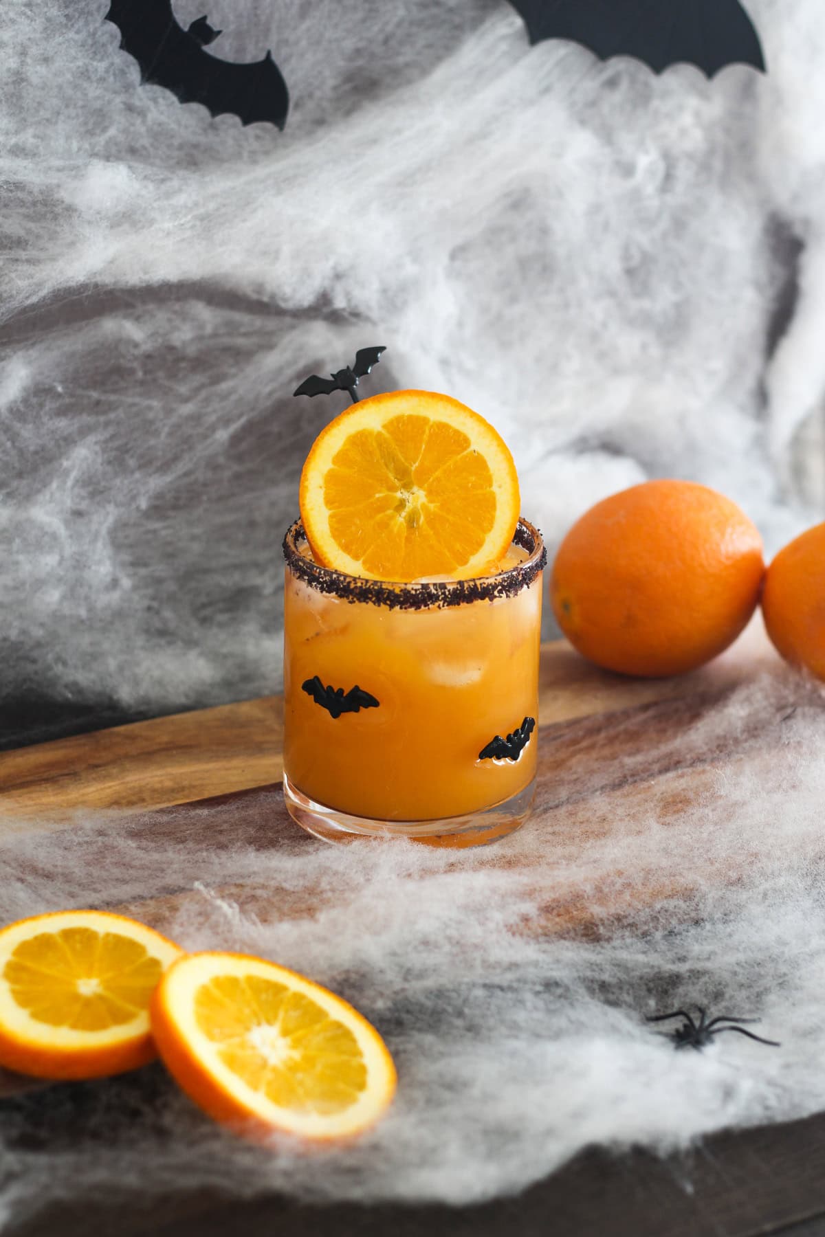 Halloween Margarita with oranges around it.