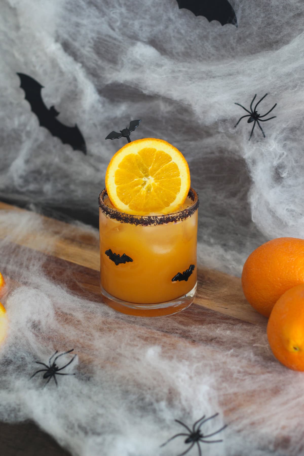 Halloween Margarita with oranges around it.