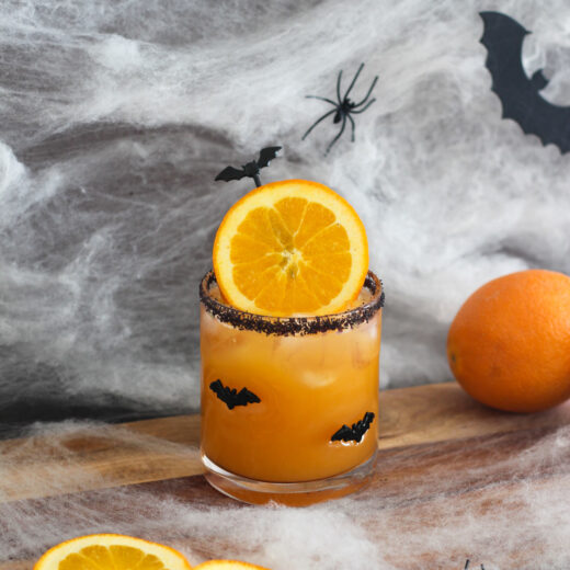 Halloween Margarita with oranges around it.