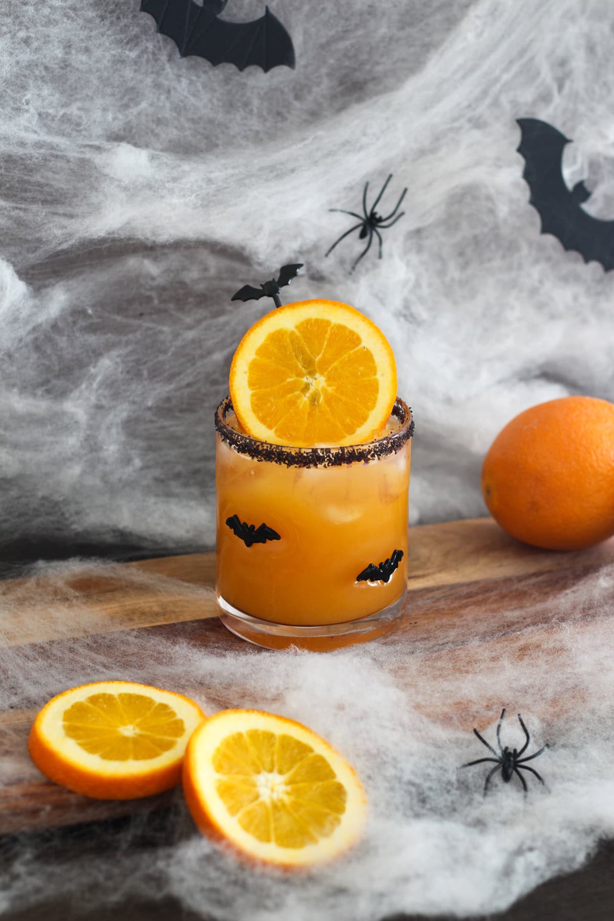 Halloween Margarita with oranges around it.