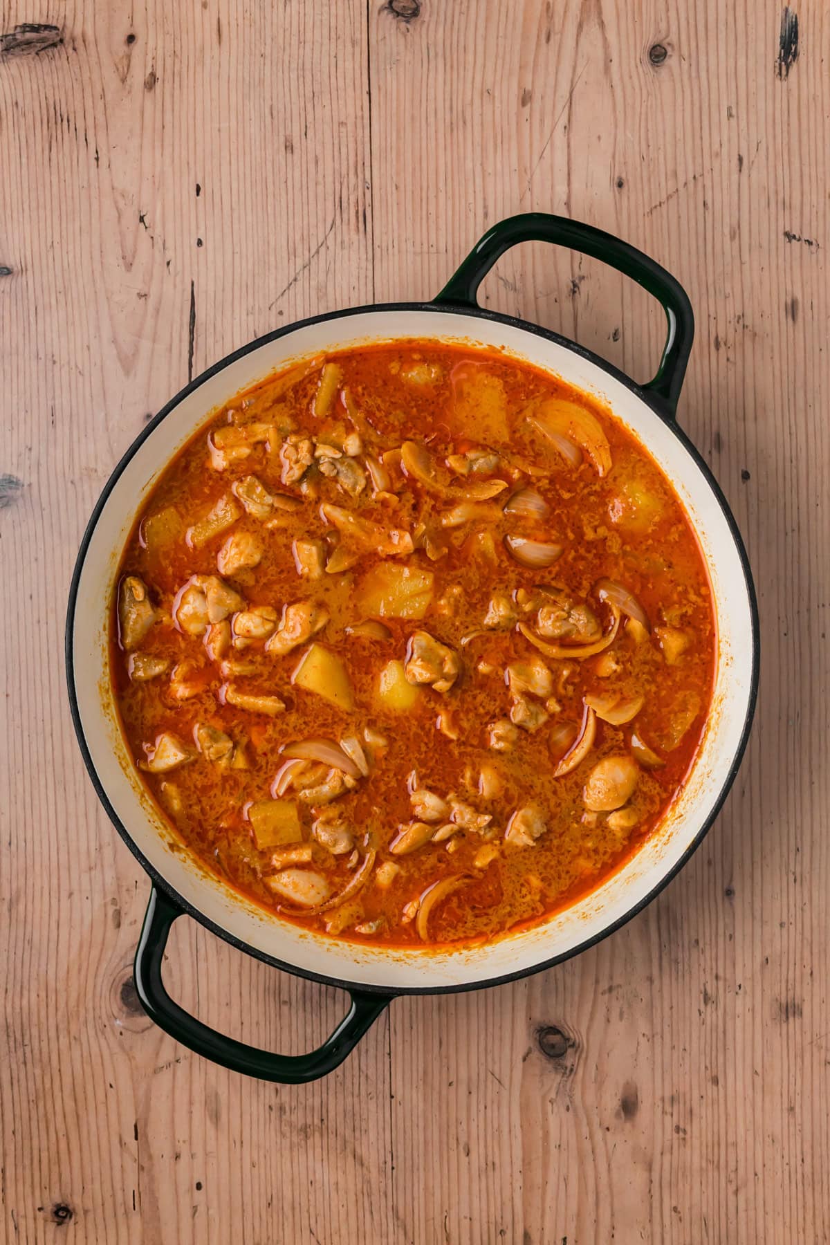 Massaman curry cooking in a pot.