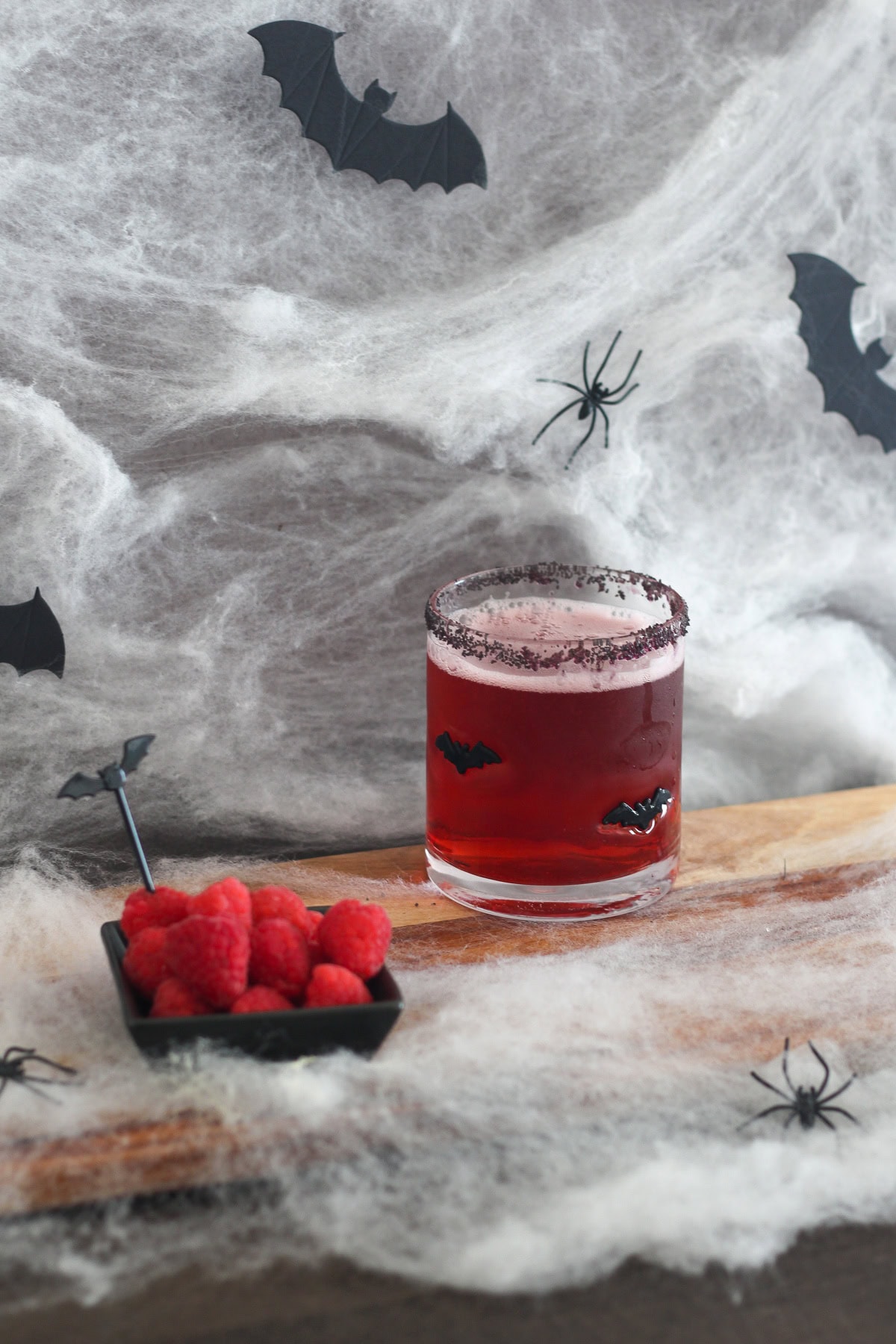 Vampire's Kiss Cocktail with raspberries on the side.